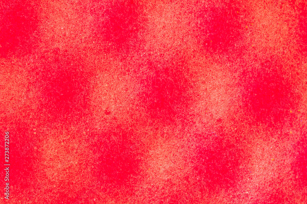 Crimson background with round dark shadows and spots on the surface. The pattern on the surface of the sponge porous material. Abstract pattern, pores. Molecular bonds.