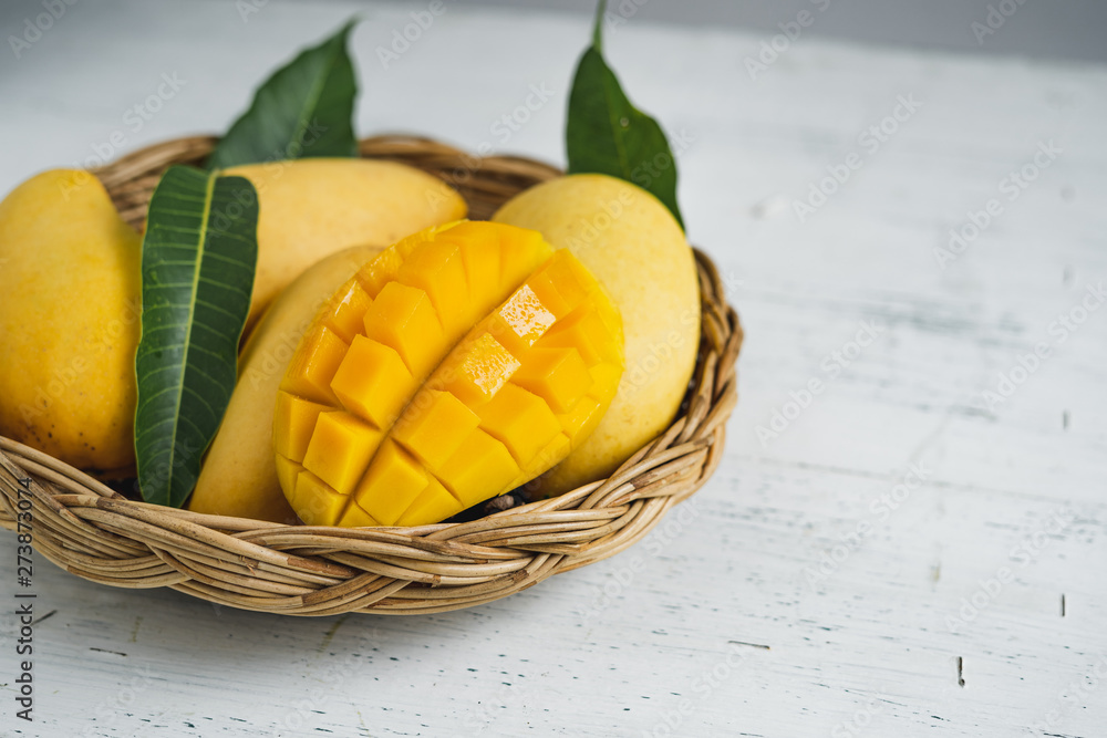 Mango in the basket on White wood background