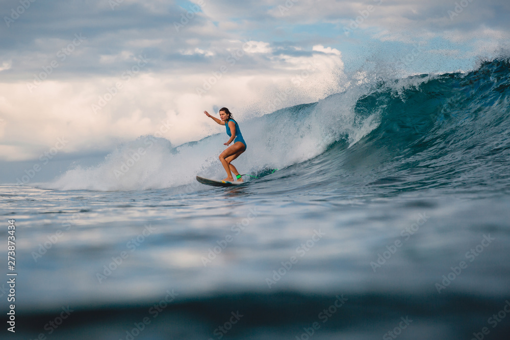 Surf girl on surfboard. Woman in ocean during surfing. Surfer and wave