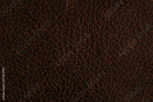 Natural dark leather abstract background detailed closeup.