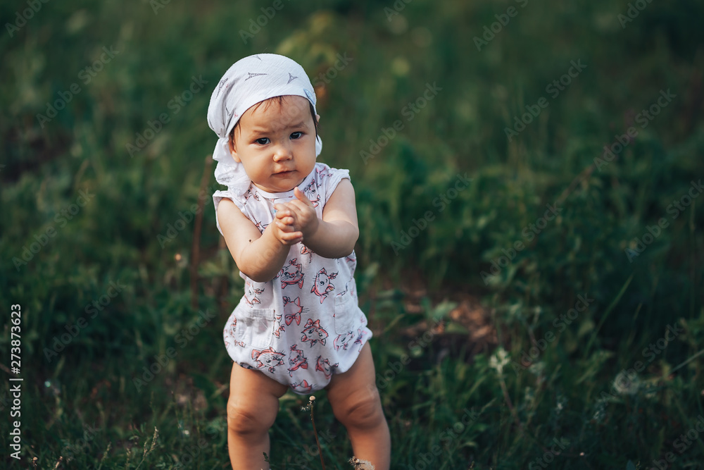 A little girl blowing soap bubbles, spring portrait beautiful one year old kid A little girl blowing soap bubbles, spring portrait beautiful one year old kid
