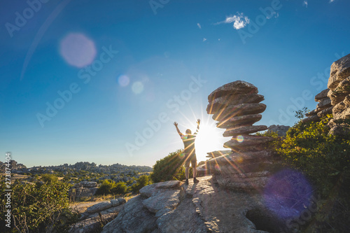 Hiker surprised by the rocky landscape of the karst mountains in the El Torcal de Antequera natural park, Malaga, Andalusia, Spain