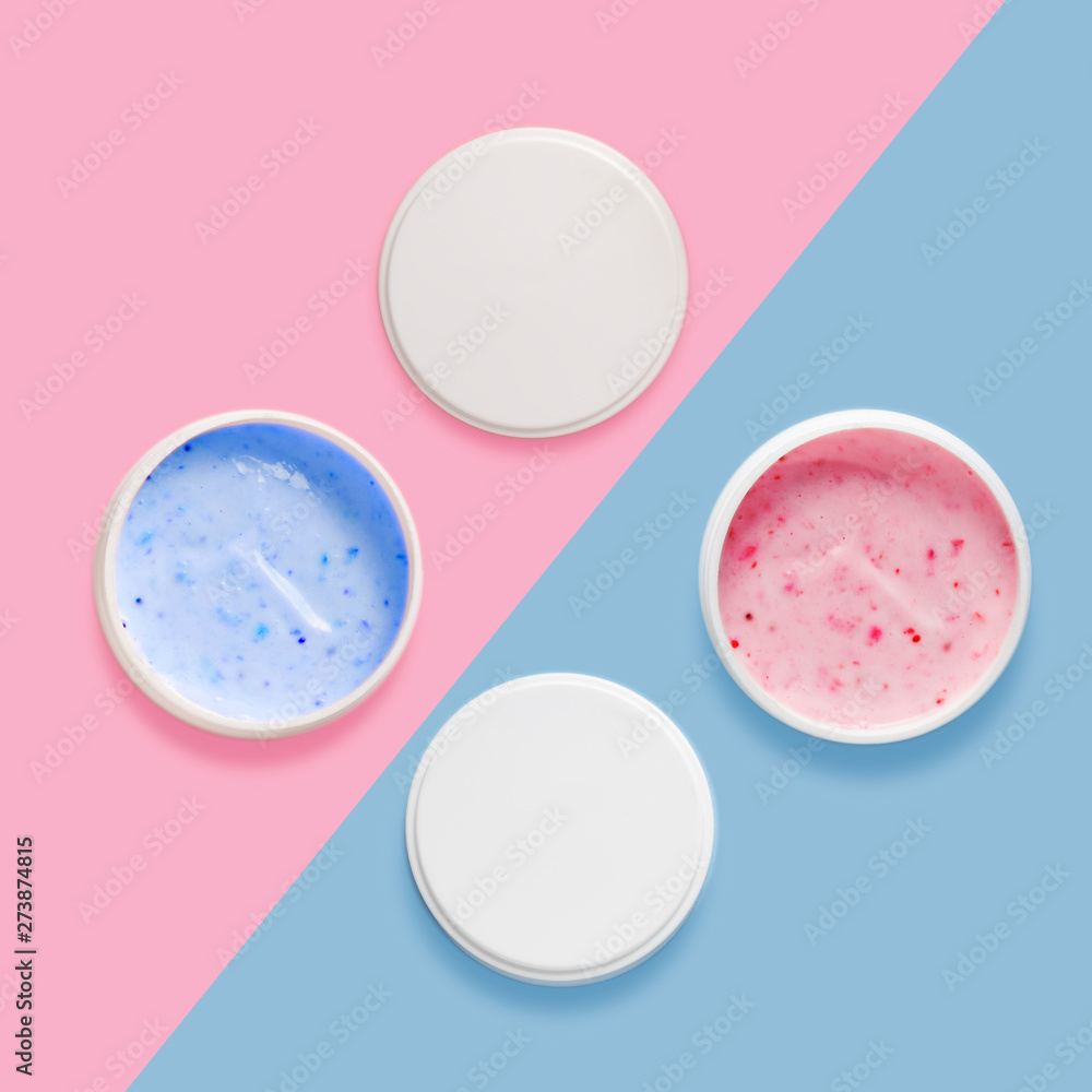 Creative beauty concept photo of cosmetic bottle tube container with cream lotion and strawberry on pink background.