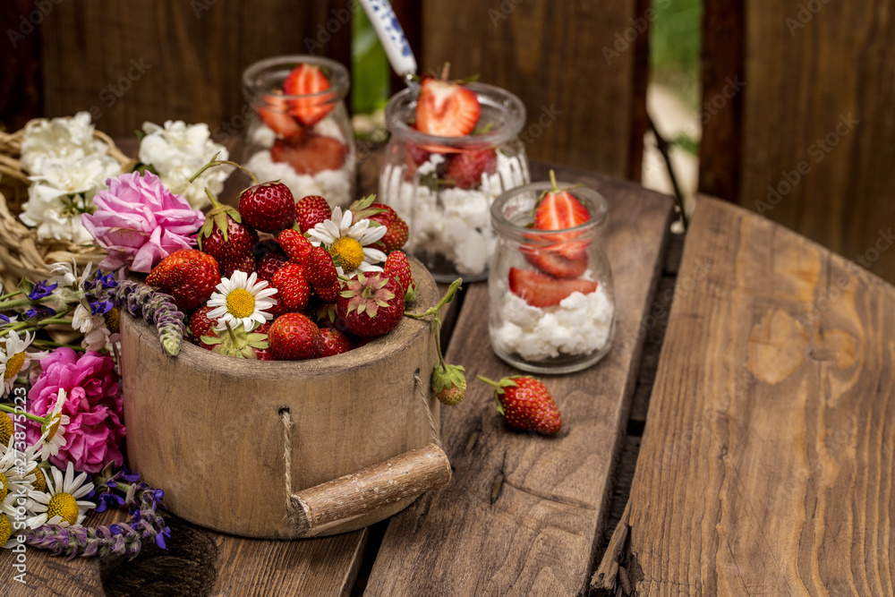 strawberry with cream cheese in glass jars, healthy summer food in a rustic style