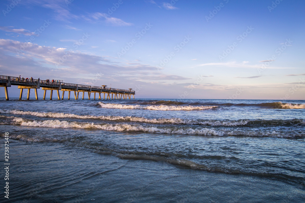 Sunset over Atlantic ocean with pier