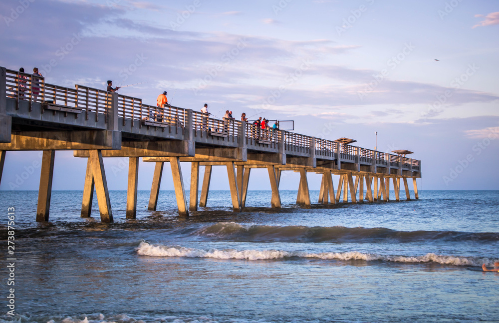 Fototapeta premium Sunset over Atlantic ocean with pier