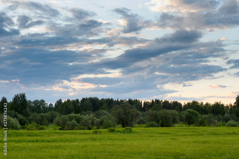 Dramatic sunset on the summer field.