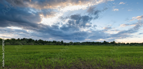 Dramatic sunset on the summer field. © Grigoriy