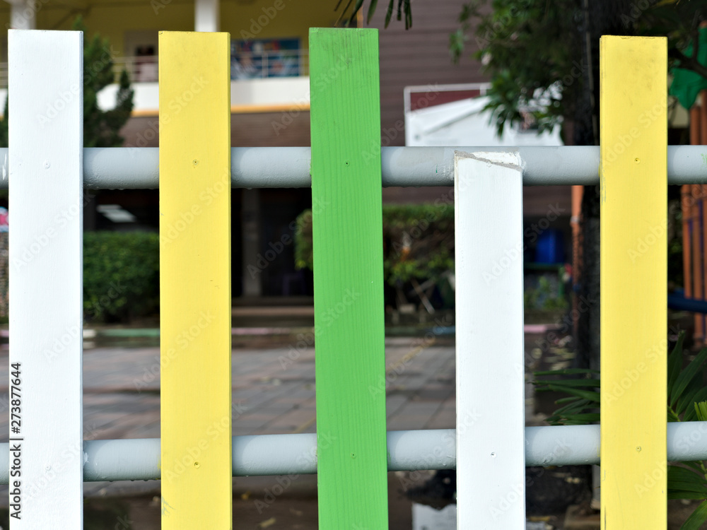 background. bright and multi colorful wooden fence, broken white picket fence background. bright and multi colorful wooden fence, broken white picket fence