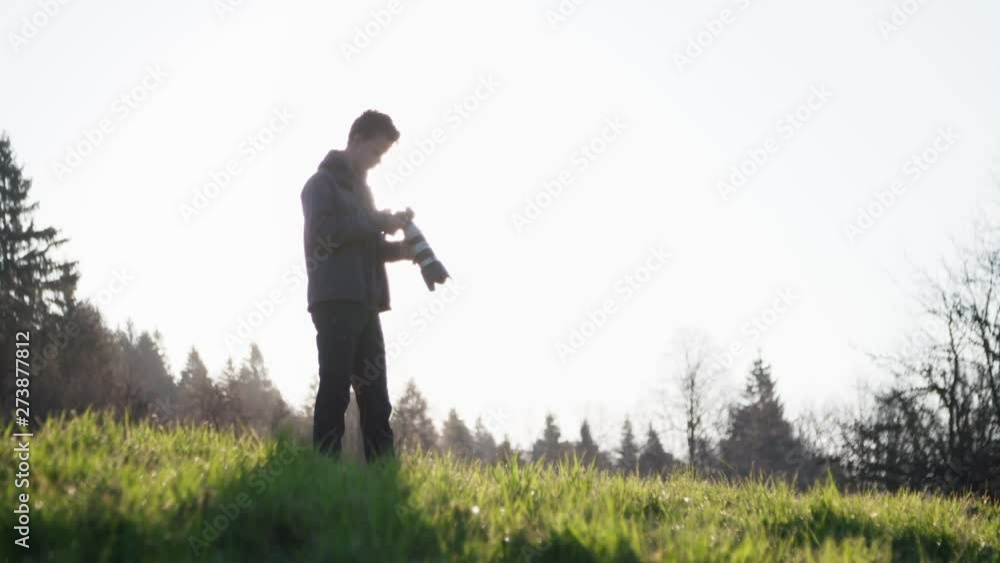 Wildlife photographer on the meadow Wildlife photographer on the meadow