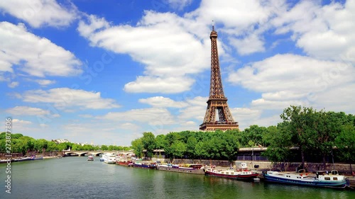 Eiffel Tower seen from the Pont de Bir Hakeim bridge in Paris France on a beautiful Spring day with blue sky and white clouds photo