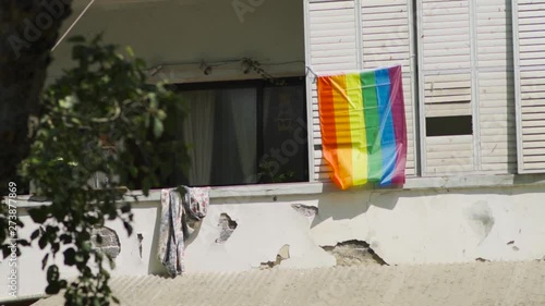 Rainbow flag hung on a balcony of an old building in Tel Aviv, Israel