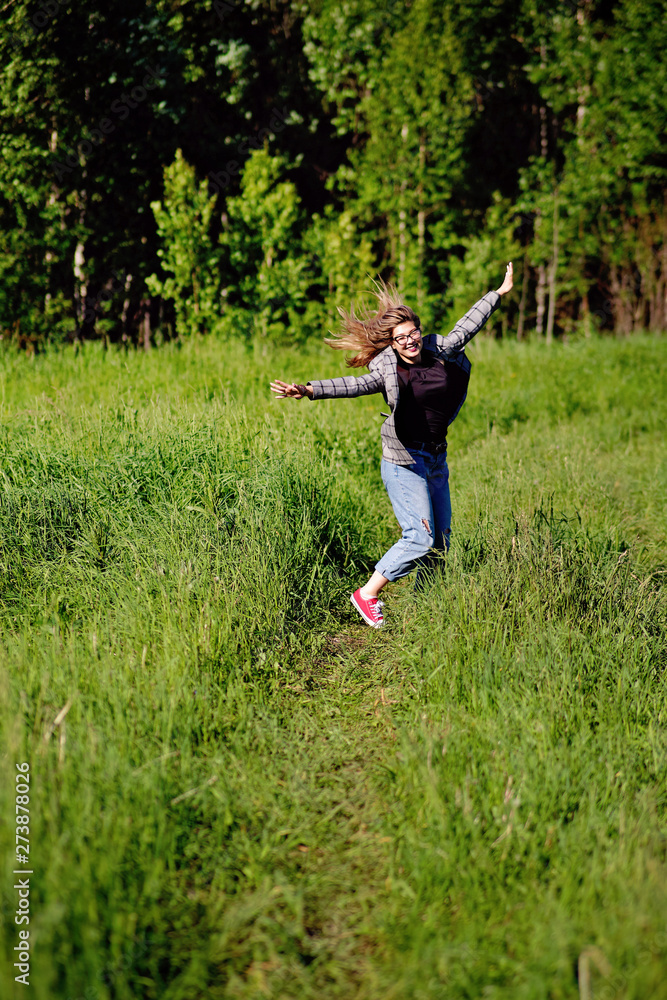 Young beautiful asian girl having fun and jumping in the forest Young beautiful asian girl having fun and jumping in the forest