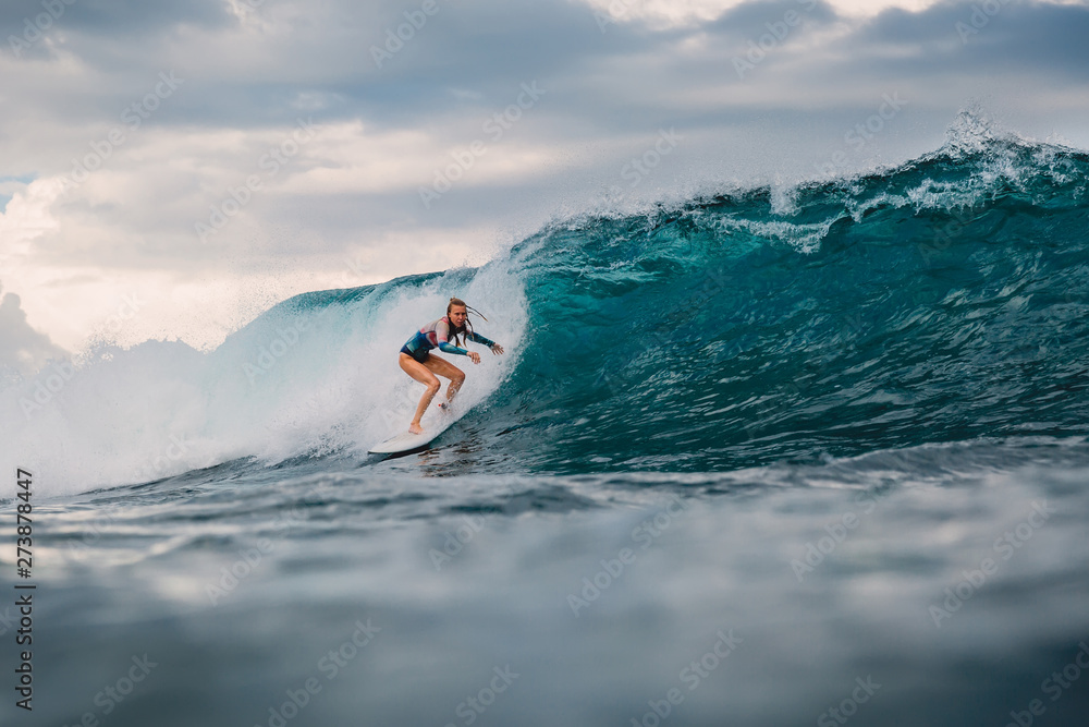 Surf girl on surfboard. Surfer woman and big blue wave