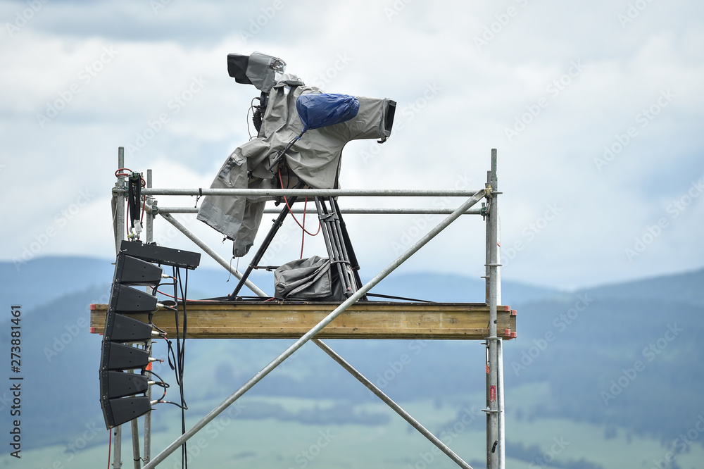 Television broadcast camera setup on a tripod and protected by a rain cover Television broadcast camera setup on a tripod and protected by a rain cover