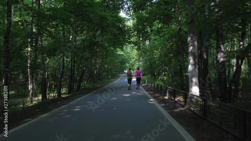 Wallpaper Mural cycle rides along bicycle lane and follows running women Torontodigital.ca