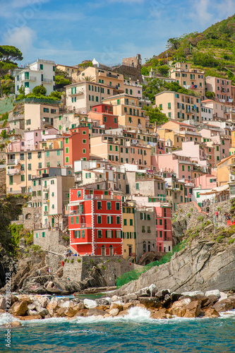 Colorful houses along the coastline of Cinque Terre area in Riomaggiore, Italy