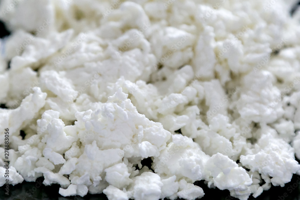 Milk curd macro photography close-up. Macro shot cottage cheese useful and tasty dairy product. Milk curd macro photography close-up. Macro shot cottage cheese useful and tasty dairy product.
