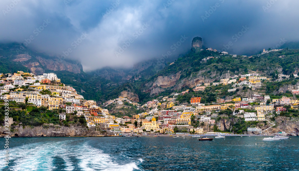 Panoramic view of beach and colorful buildings  in Positano town at Amalfi Coast, Italy.