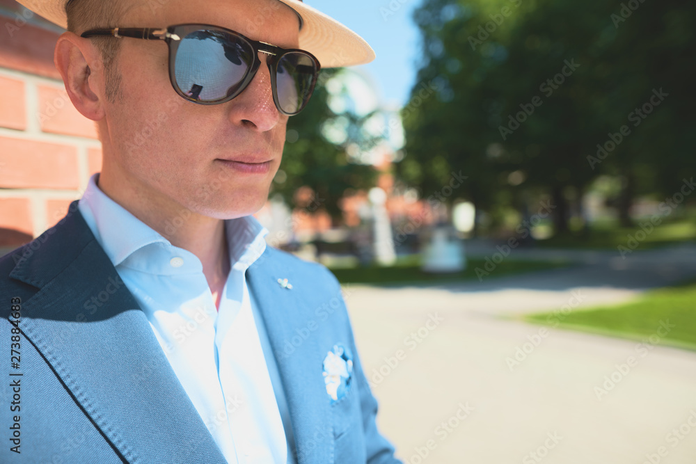 Portrait of a guy in a jacket on a brick wall background.Classic elegant formal men's outfit. Businessman Portrait of a guy in a jacket on a brick wall background.Classic elegant formal men's outfit. Businessman