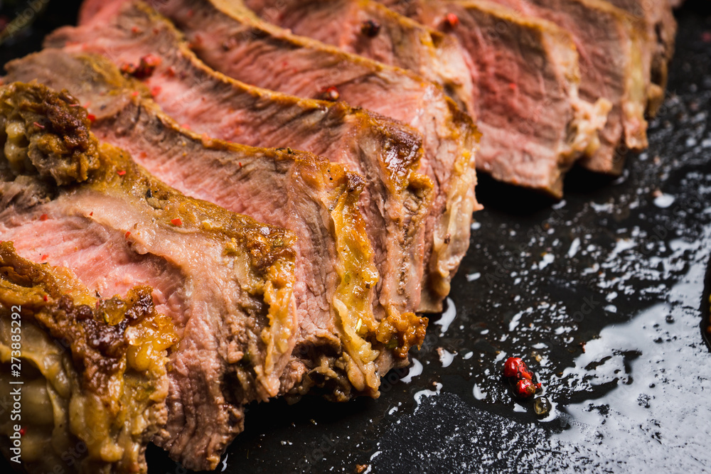 Grilled meat medium rare on the rustic background. Selective focus. Shallow depth of field. Grilled meat medium rare on the rustic background. Selective focus. Shallow depth of field.