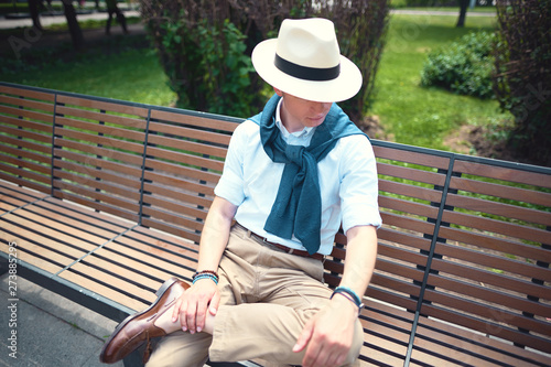 Close portrait of a guy sitting on a bench 