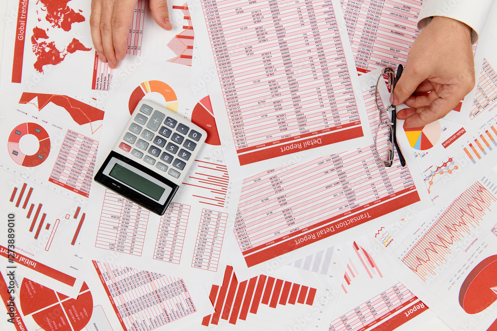 Obraz premium Flat top view of businessman working and calculating finance, reads and writes reports. Business financial accounting concept.