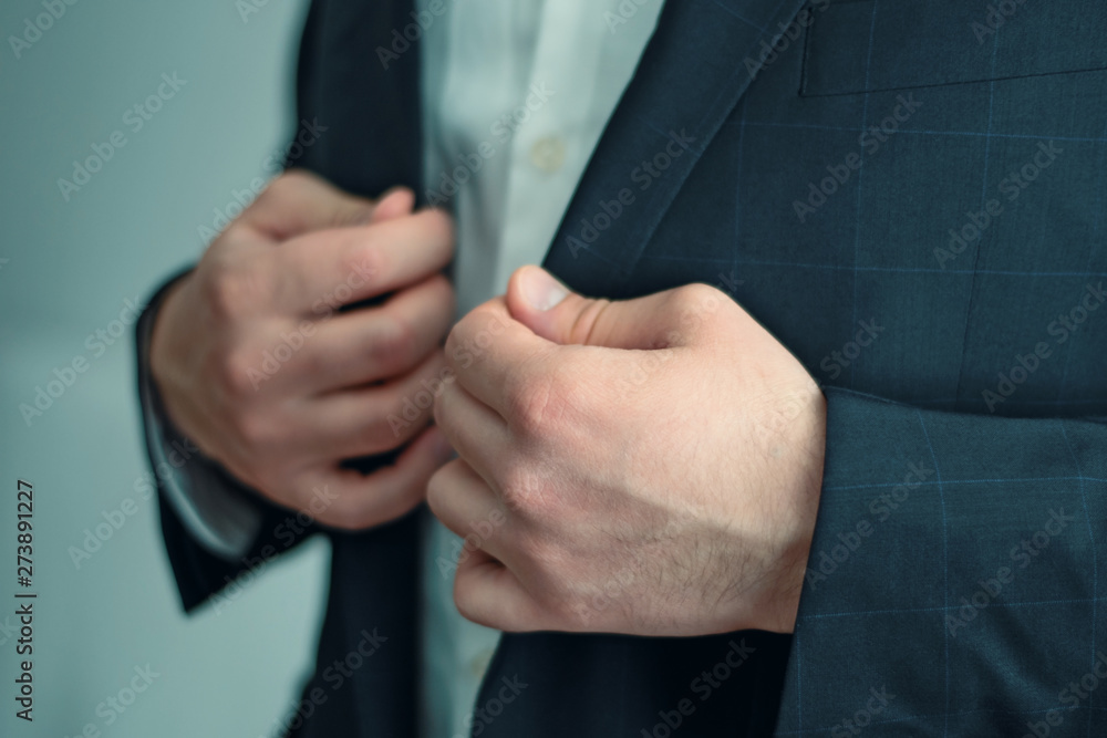 the man straightens his jacket