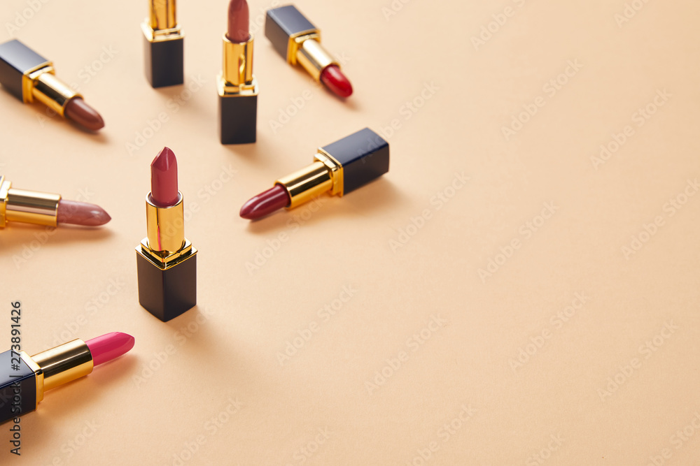 Obraz premium various red shades of lipsticks on beige