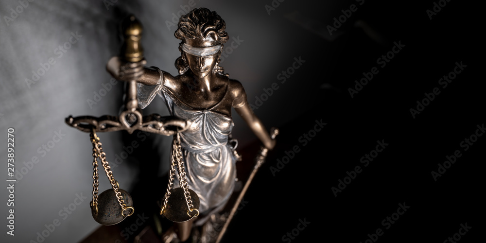 Statue of lady justice on bright background - Side view with copy space.