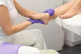 Beautifully cherish female foot in the hand of the masseur