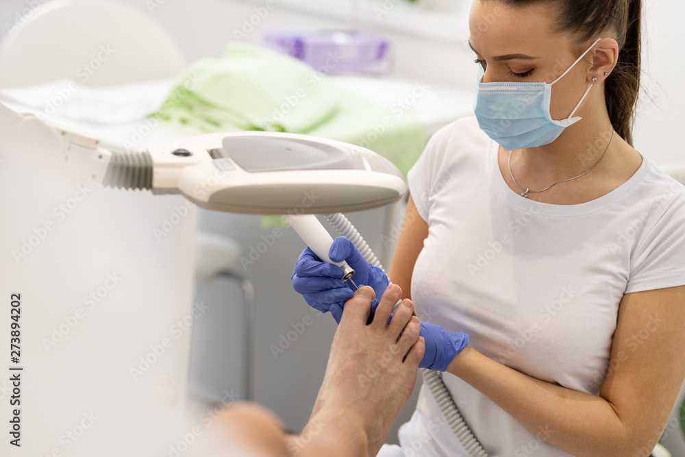 Close-up of manicurist removing cuticle from the nails of feet Close-up of manicurist removing cuticle from the nails of feet