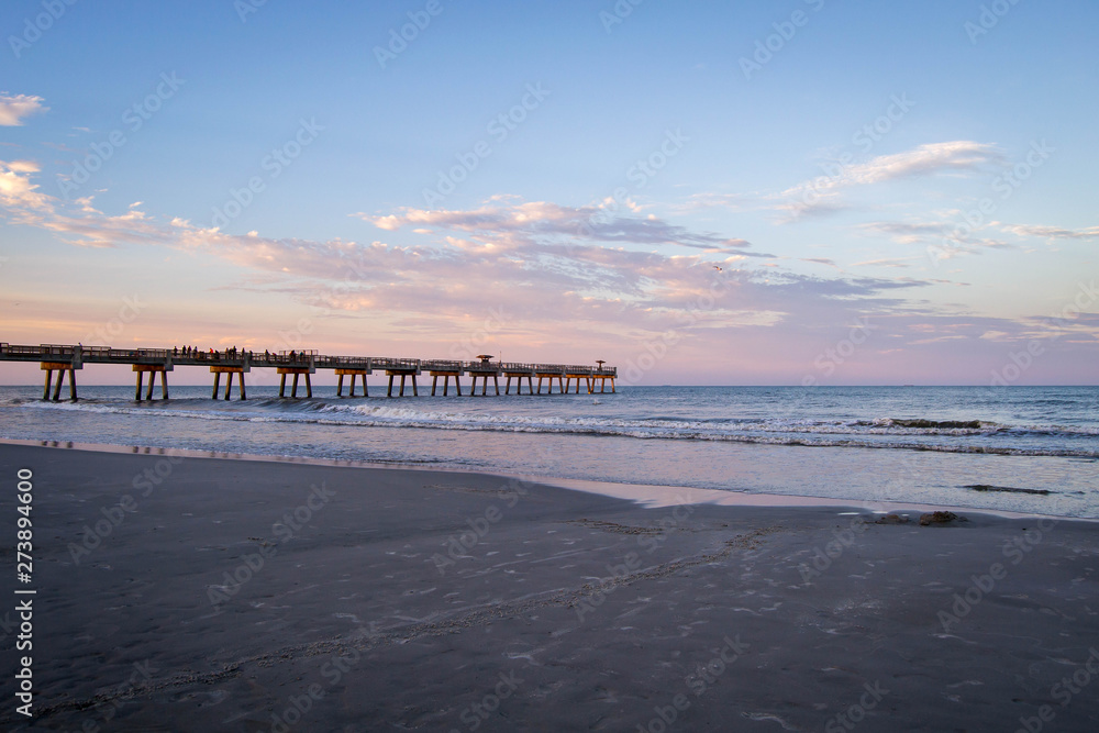 Sunset over Atlantic ocean with pier
