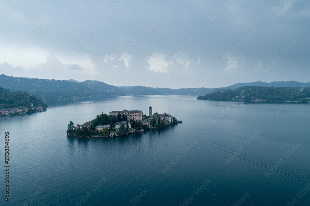 San Giulio island on Lake Orta (Piedmont, Italy) at evening. Aerial view. Italian landscape.
