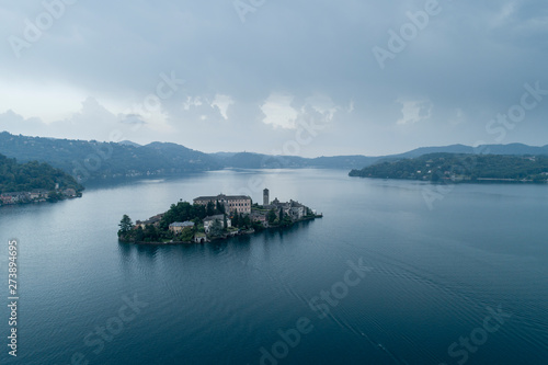 San Giulio island on Lake Orta (Piedmont, Italy) at evening. Aerial view. Italian landscape.