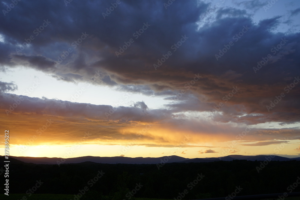 Brilliant Sunset with Clouds Over Mountains Brilliant Sunset with Clouds Over Mountains