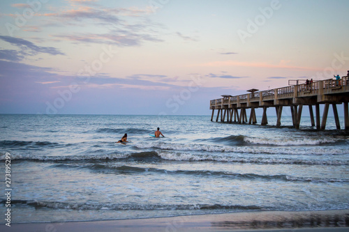 Photography People surfing by pier in the sunset