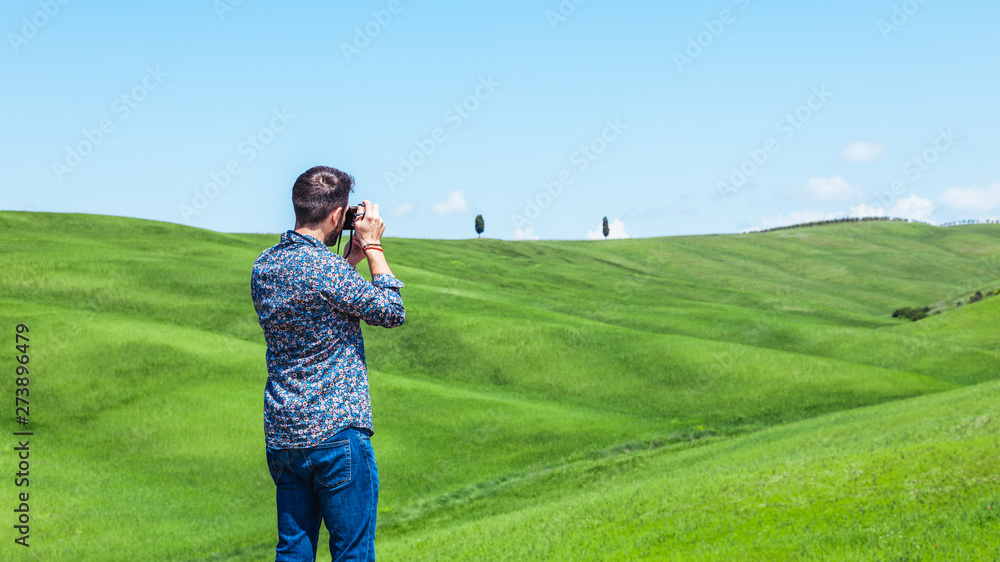 Young man traveling through Tuscany, Val d'Orcia