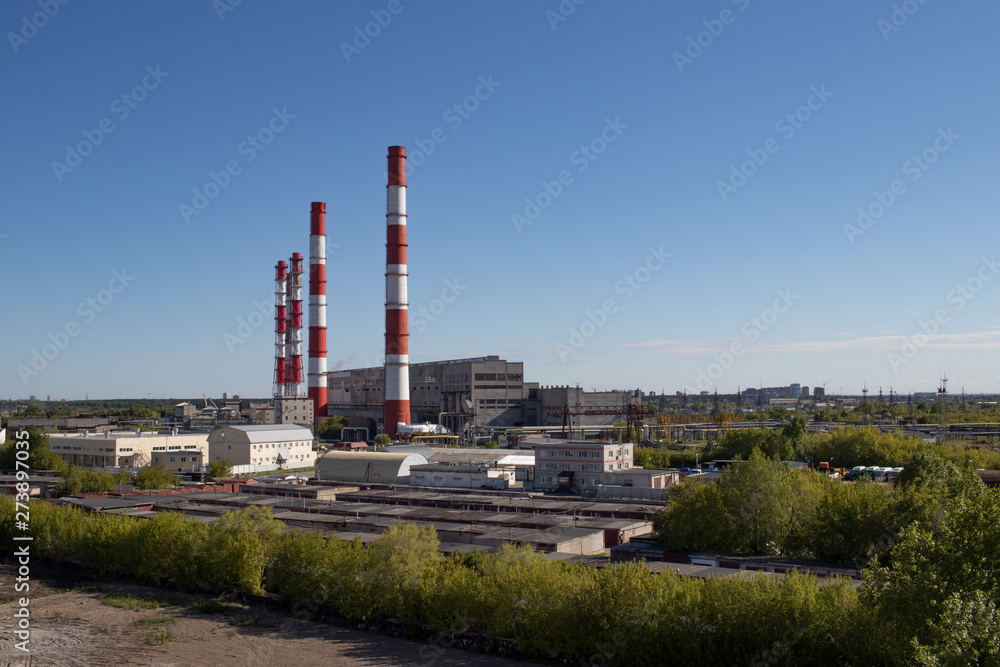 view of the industry, pipes, garages, factory buildings, warm day with a bright clear blue sky