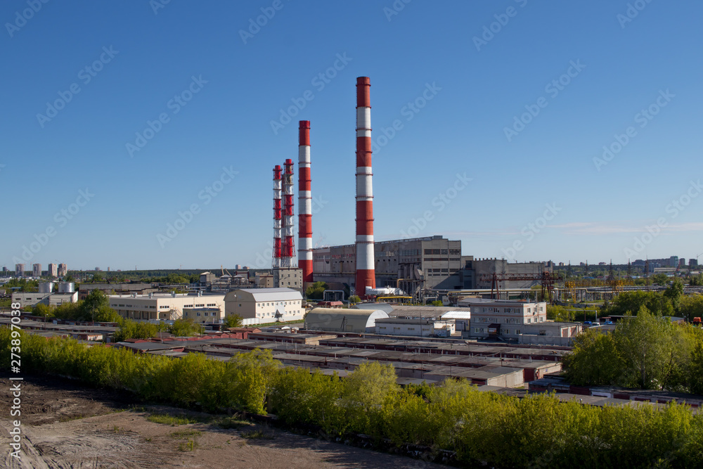 view of the industry, pipes, garages, factory buildings, warm day with a bright clear blue sky