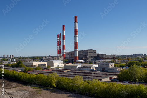 view of the industry, pipes, garages, factory buildings, warm day with a bright clear blue sky