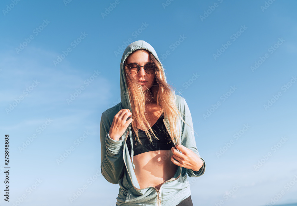 Young woman in comfort fashion sport outfit enjoing with calm morning sun Young woman in comfort fashion sport outfit enjoing with calm morning sun