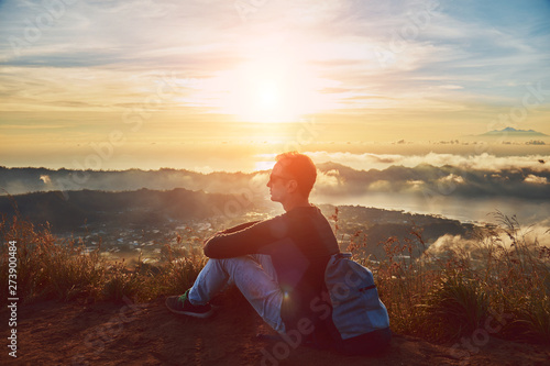 Man enjoying nice landscape from a top of mountain Batur, Bali, Indonesia.