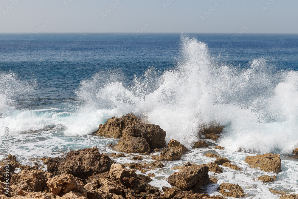 Powerful waves splashing on a rocky beach of Cyprus