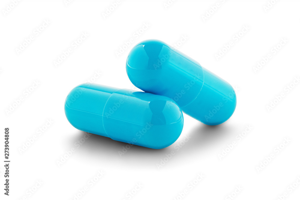 Two medical pills on white isolated background with shadow.