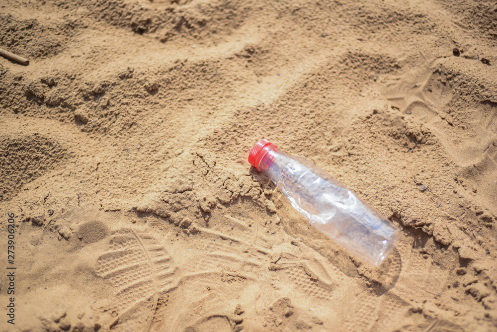 Reduce the use of plastic bottles reuse,recycling the Empty used plastic bottle.A discarded plastic bottle is washed up on a sandy beach.Ecology,earth protection,nature conservation,pollution sea. Reduce the use of plastic bottles reuse,recycling the Empty used plastic bottle.A discarded plastic bottle is washed up on a sandy beach.Ecology,earth protection,nature conservation,pollution sea.