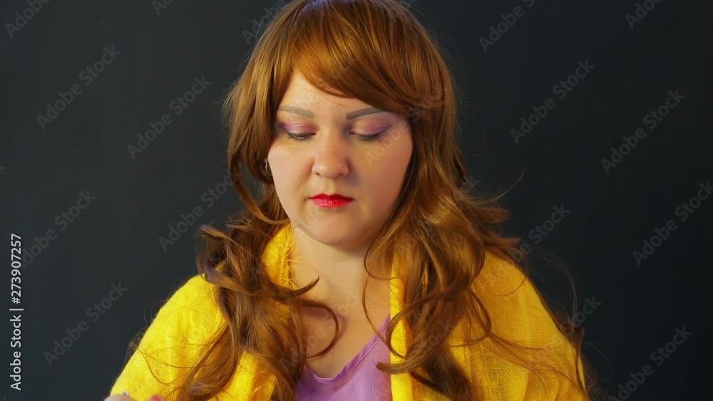 Red-haired Girl in a cafe at the table drinking green tea and eating cake with a spoon Red-haired Girl in a cafe at the table drinking green tea and eating cake with a spoon