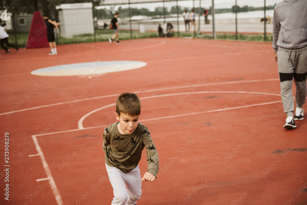 A little boy on a basketball court