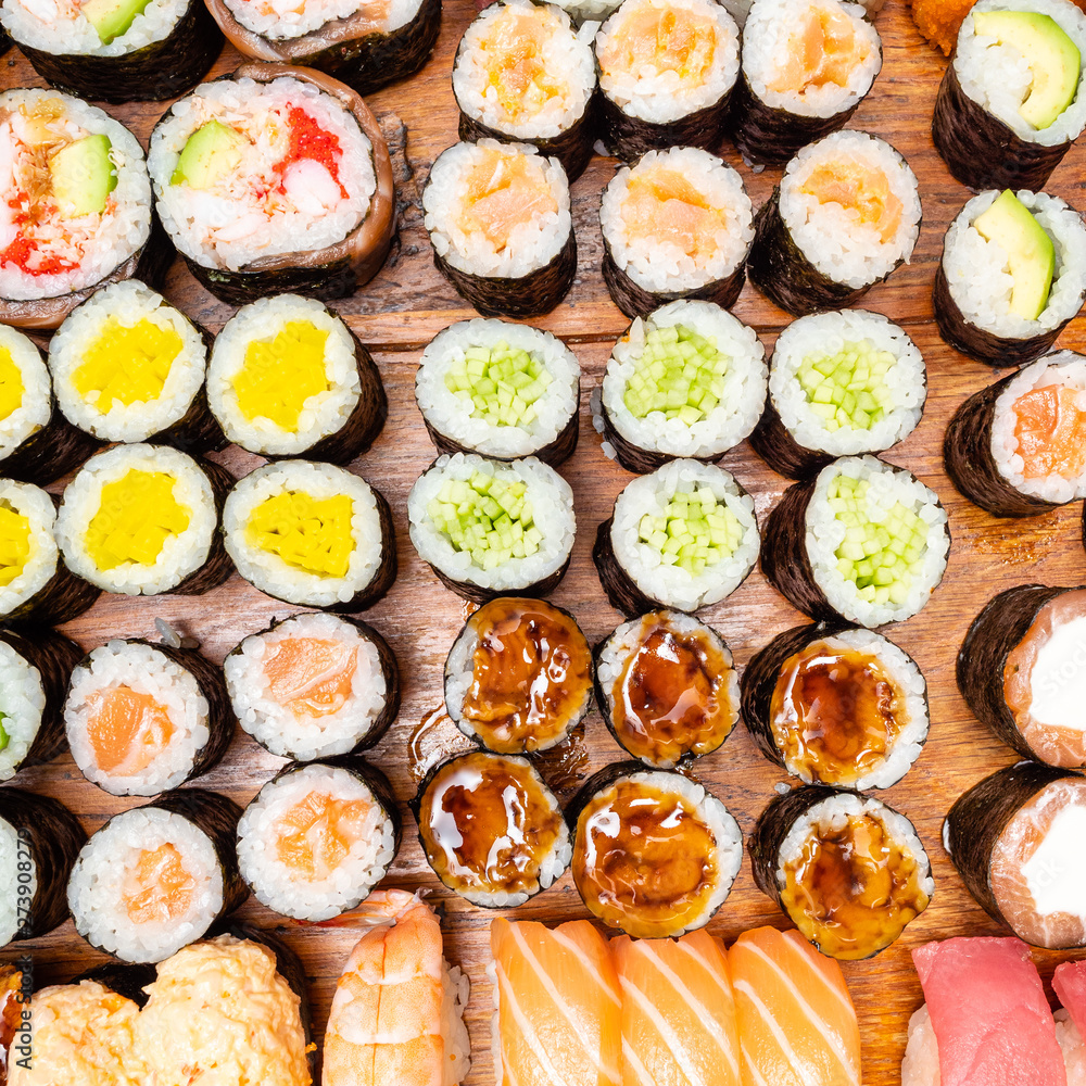 different sushi and rolls on wooden table different sushi and rolls on wooden table