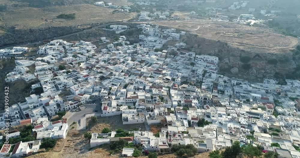 Aerial birds eye view video of village Lindos, Rhodes island, Dodecanese, Greece. Mediterranean sea coast. Famous tourist destination. Aerial birds eye view video of village Lindos, Rhodes island, Dodecanese, Greece. Mediterranean sea coast. Famous tourist destination.